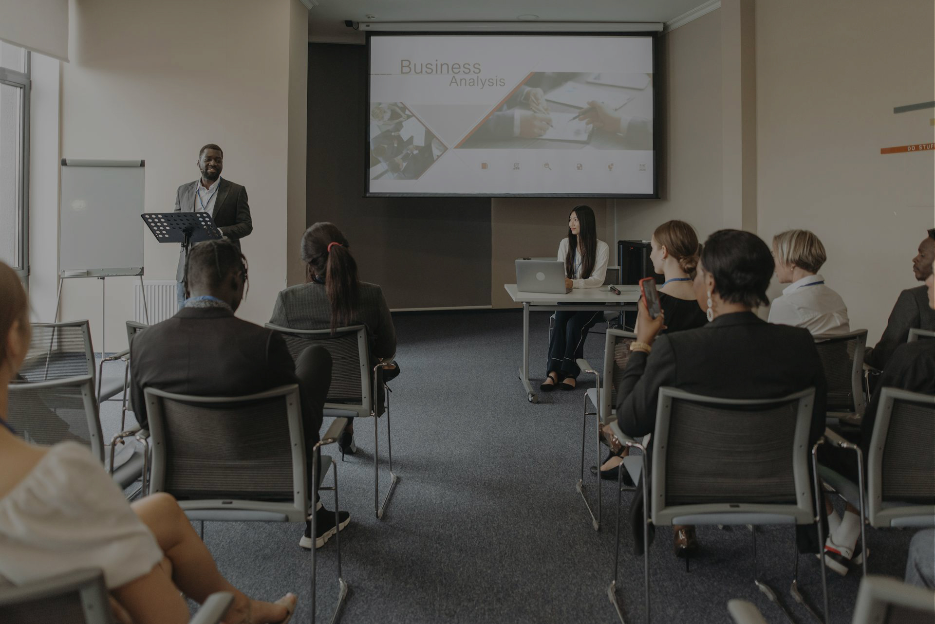 an executive presenting to others in a meeting