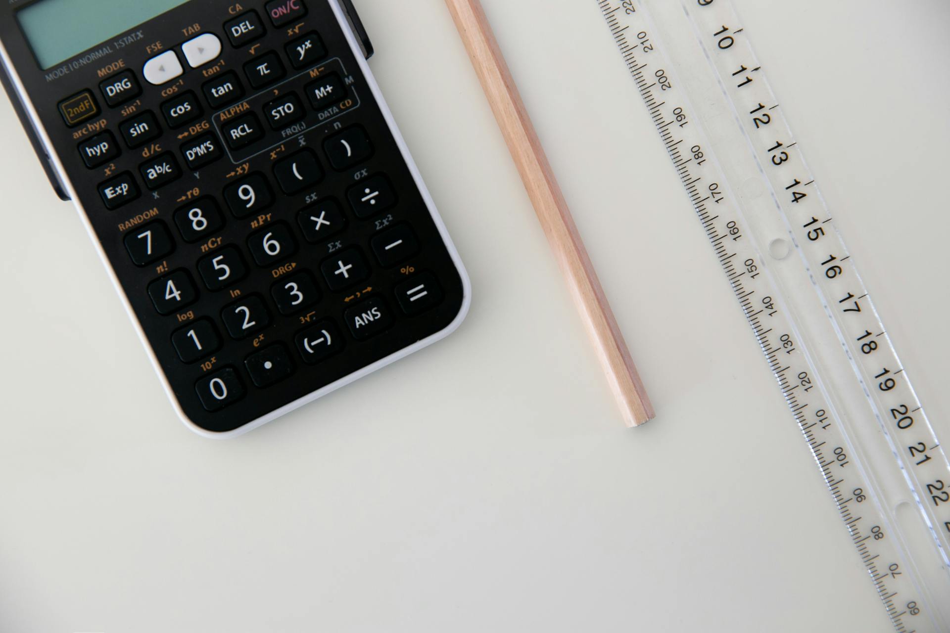 View of a calculator, pencil and ruler